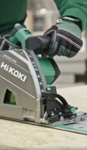 A close up shot of the HiKOKI 3606DPA Plunge Saw at work on a large sheet